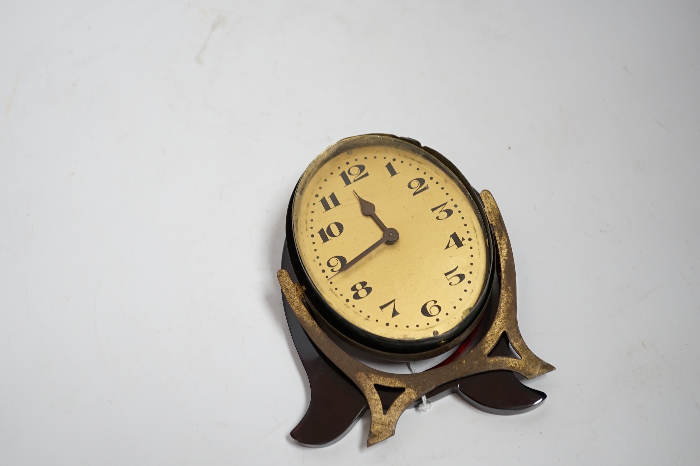 A cherry amber Bakelite framed Art Deco clock (needs assembly)